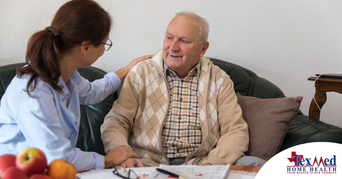 A caregiver compassionately listens to an older man, representing the kind of patience and empathy that help with communicating with clients who have dementia.